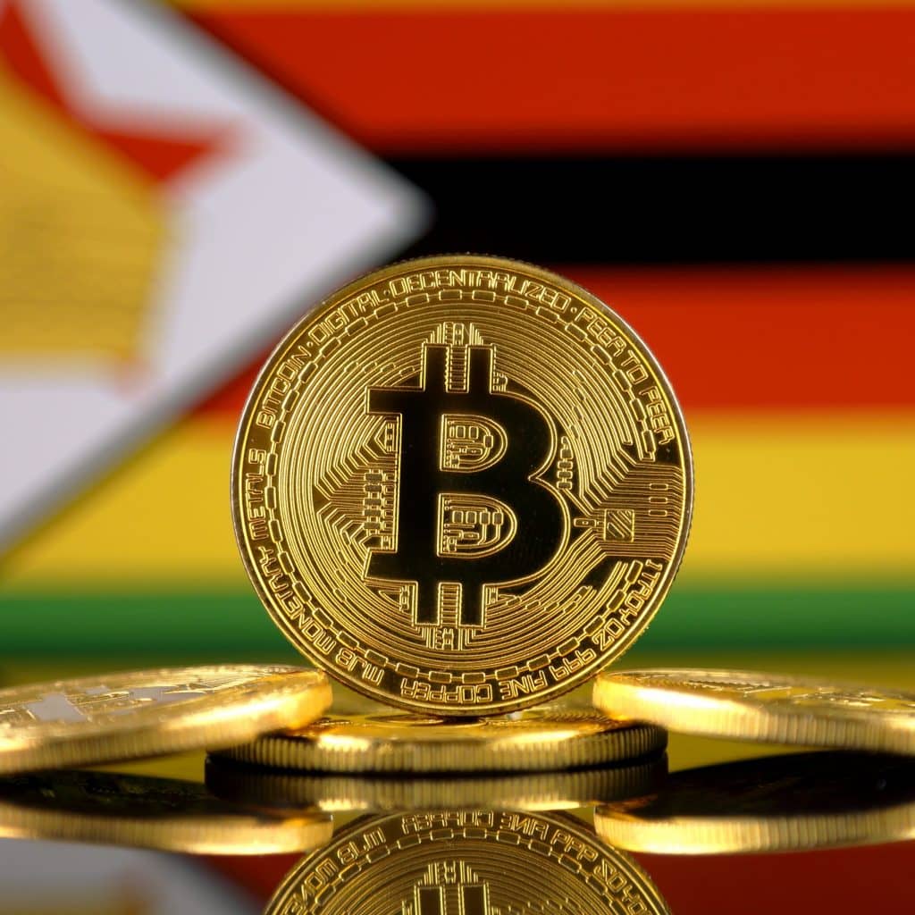 Physical version of Bitcoin (new virtual money) and Africa Flag. Conceptual image for investors in cryptocurrency and Blockchain Technology in Africa.